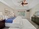 Bright main bedroom features a large window, tray ceiling with fan, and wood-look flooring at 1257 Mill Race Ln, Matthews, NC 28104
