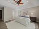 Spacious main bedroom featuring a tray ceiling, ceiling fan, and ample natural light for a cozy retreat at 1257 Mill Race Ln, Matthews, NC 28104