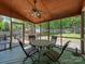 Inviting screened porch featuring an outdoor dining table and scenic backyard views at 1257 Mill Race Ln, Matthews, NC 28104