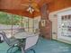 Relaxing screened porch with wood ceiling, a ceiling fan and an outdoor dining table at 1257 Mill Race Ln, Matthews, NC 28104