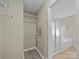 Walk-in closet is ready to be organized with wire shelving, a shoe rack, and access to bathroom at 1257 Mill Race Ln, Matthews, NC 28104