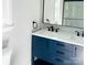 Modern bathroom featuring a double sink vanity with navy blue cabinets and black hardware at 12620 Sulgrave Dr, Huntersville, NC 28078