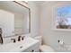 Bright bathroom features a large mirror and natural light from the window at 12620 Sulgrave Dr, Huntersville, NC 28078