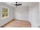 Bright bedroom featuring hardwood floors, a modern ceiling fan, and closet at 12620 Sulgrave Dr, Huntersville, NC 28078