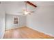 Bright bedroom with hardwood floors, a neutral ceiling fan, and natural light from a single window at 12620 Sulgrave Dr, Huntersville, NC 28078