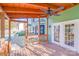 A covered patio has a ceiling fan and overlooks the pool and fenced yard at 12620 Sulgrave Dr, Huntersville, NC 28078