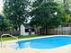 Refreshing pool surrounded by a well-manicured lawn and privacy fence at 12620 Sulgrave Dr, Huntersville, NC 28078