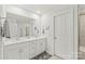 Bathroom featuring dual sinks with modern cabinets and a large mirror at 1316 Colgher St, Mint Hill, NC 28227