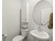 Modern bathroom featuring a round mirror, a vessel sink, and neutral paint at 1316 Colgher St, Mint Hill, NC 28227