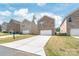 Street view of the brick home with a 2-car garage and a long driveway at 1316 Colgher St, Mint Hill, NC 28227