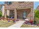 Welcoming front porch with seating and colorful flowers, offering a cozy curb appeal at 1316 Colgher St, Mint Hill, NC 28227