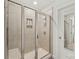Shower featuring frameless glass doors, a built-in seat, and tiled walls at 1316 Colgher St, Mint Hill, NC 28227