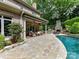 Beautiful backyard features a pool and stone patio with an outdoor kitchen and fireplace at 14650 Trading Path Way, Charlotte, NC 28277