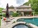 The backyard features a private pool, hot tub, patio, and manicured greenery for outdoor living at 14650 Trading Path Way, Charlotte, NC 28277