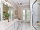 Bright bathroom with dual vanity, white cabinets, and glass shower at 14650 Trading Path Way, Charlotte, NC 28277