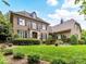 Elegant brick home with a manicured lawn and dark shutters at 14650 Trading Path Way, Charlotte, NC 28277