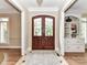 Elegant foyer with hardwood floors and double glass doors at 14650 Trading Path Way, Charlotte, NC 28277