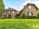Charming two-story home with manicured lawn, mature trees, and traditional architecture at 14650 Trading Path Way, Charlotte, NC 28277