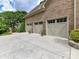 Three car garage with carriage doors and well manicured landscaping at 14650 Trading Path Way, Charlotte, NC 28277