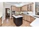 Well-appointed kitchen featuring a center island, custom cabinets and modern appliances at 14650 Trading Path Way, Charlotte, NC 28277