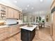 Spacious kitchen with custom cabinetry, island, and seamless flow to dining area at 14650 Trading Path Way, Charlotte, NC 28277