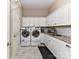Well-equipped laundry room with white cabinets and granite countertop at 14650 Trading Path Way, Charlotte, NC 28277
