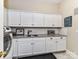 Laundry room with white cabinets, granite countertop, and modern appliances at 14650 Trading Path Way, Charlotte, NC 28277