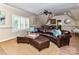 Spacious living room with hardwood floors, brown leather sofas and beamed ceilings at 14650 Trading Path Way, Charlotte, NC 28277