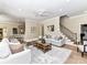 Inviting living room featuring neutral decor and access to kitchen and staircase at 14650 Trading Path Way, Charlotte, NC 28277