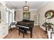 Bright living room with a piano, built-in shelving, and hardwood floors at 14650 Trading Path Way, Charlotte, NC 28277