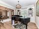 Bright living room with a piano, built-in shelving, and views of the dining room at 14650 Trading Path Way, Charlotte, NC 28277