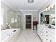 Bathroom featuring dual vanity, soaking tub, and glass-enclosed shower at 14650 Trading Path Way, Charlotte, NC 28277