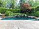 Backyard pool and beautiful landscaping with trees, bushes and flowers at 14650 Trading Path Way, Charlotte, NC 28277