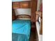 RV bedroom featuring a queen bed with overhead storage and a window for natural light at 148 Sunshine Trl # A165, Mount Gilead, NC 27306