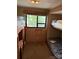 RV bedroom featuring two bunk beds, a ladder, and cabinets at 148 Sunshine Trl # A165, Mount Gilead, NC 27306
