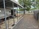 White RV with a metal carport cover, gravel area and pavers at 148 Sunshine Trl # A165, Mount Gilead, NC 27306