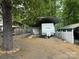 White RV with a metal carport cover surrounded by gravel and fencing at 148 Sunshine Trl # A165, Mount Gilead, NC 27306