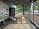 White RV with a metal carport cover surrounded by gravel and pavers at 148 Sunshine Trl # A165, Mount Gilead, NC 27306
