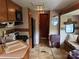 Open RV kitchen featuring wood cabinetry, black appliances, laminate countertops, and tile flooring at 148 Sunshine Trl # A165, Mount Gilead, NC 27306
