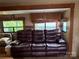 A large brown leather sofa in a well-lit RV living room with windows at 148 Sunshine Trl # A165, Mount Gilead, NC 27306