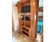 View of a built-in wall unit with shelves, a tv, and access to a bedroom at 148 Sunshine Trl # A165, Mount Gilead, NC 27306