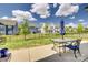Spacious backyard with a patio set and a lush green lawn surrounded by a black metal fence at 14925 Baldridge Dr, Huntersville, NC 28078