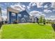 Picture of a landscaped backyard with a well maintained lawn and a black metal fence at 14925 Baldridge Dr, Huntersville, NC 28078
