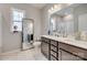 Bright bathroom featuring double vanity sinks, a large mirror, and a full-length mirror at 14925 Baldridge Dr, Huntersville, NC 28078