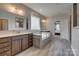 Bathroom featuring a soaking tub, double vanities, and neutral tiling at 14925 Baldridge Dr, Huntersville, NC 28078