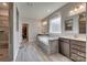 Bathroom featuring a soaking tub, double vanities, and neutral tiling at 14925 Baldridge Dr, Huntersville, NC 28078