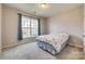 Bright bedroom with neutral walls, carpet flooring, and a large window providing ample natural light at 14925 Baldridge Dr, Huntersville, NC 28078
