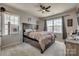 Comfortable bedroom showcasing a large bed, two windows, and a modern ceiling fan at 14925 Baldridge Dr, Huntersville, NC 28078