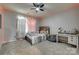Charming bedroom offering a cozy bed, desk area, and a stylish ceiling fan at 14925 Baldridge Dr, Huntersville, NC 28078