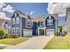Beautiful blue two-story home with three-car garage and manicured lawn at 14925 Baldridge Dr, Huntersville, NC 28078